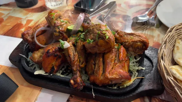 Tandoori chicken on a sizzling platter